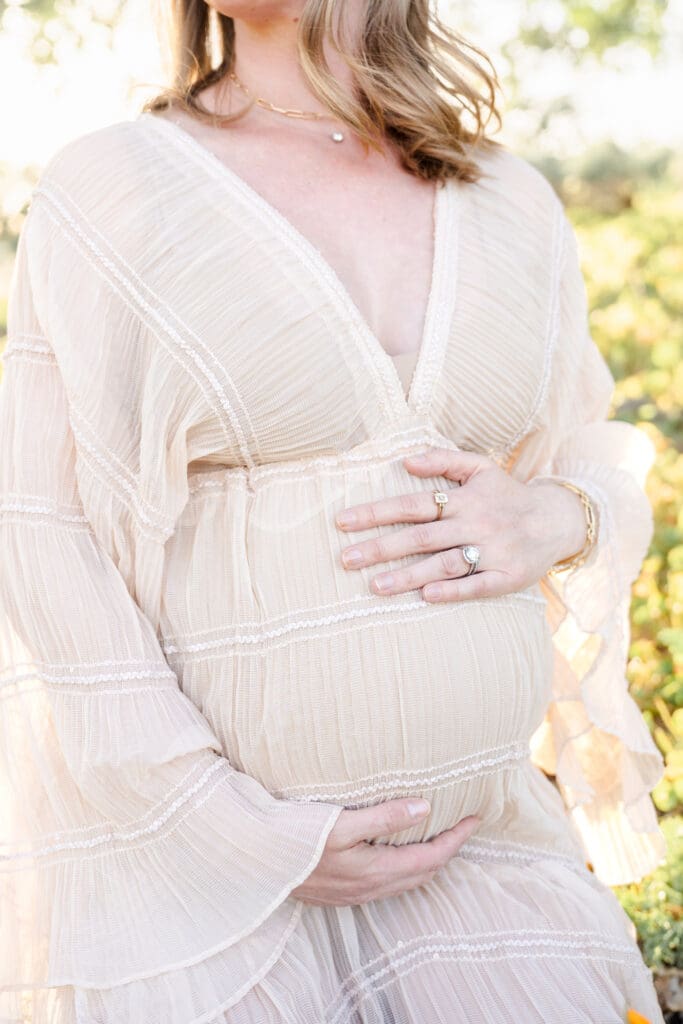 Close up of an expecting mom holding her belly.