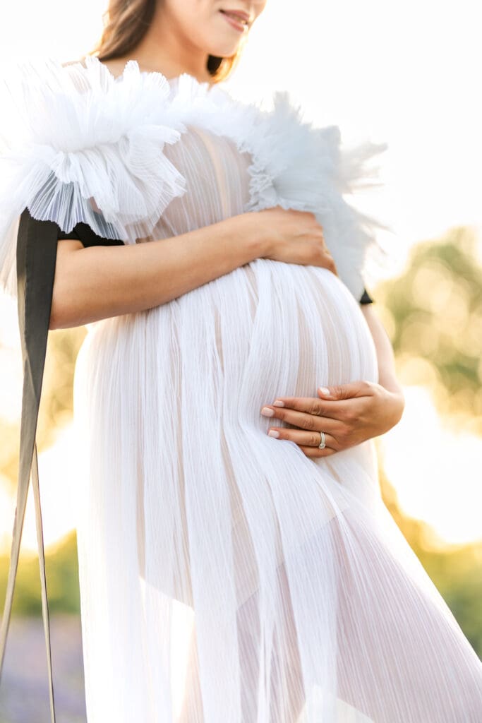 Maternity photographer serving Sacramento and El Dorado Hills capturing portraits among purple wildflowers