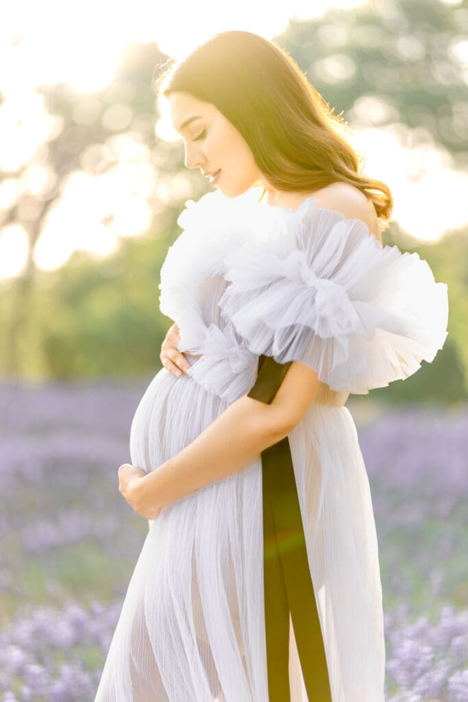 El Dorado Hills maternity photos featuring an expecting mother surrounded by purple lupine wildflowers