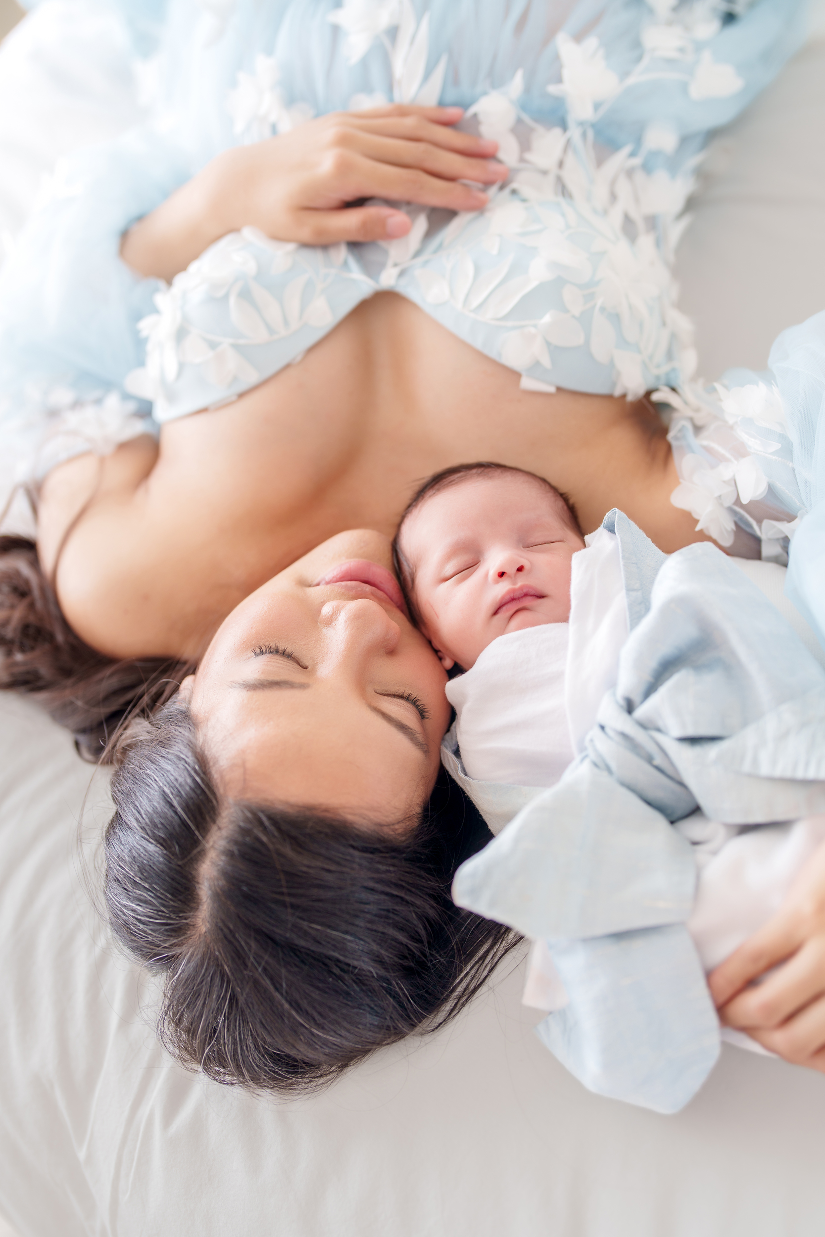 baby on bed with mother